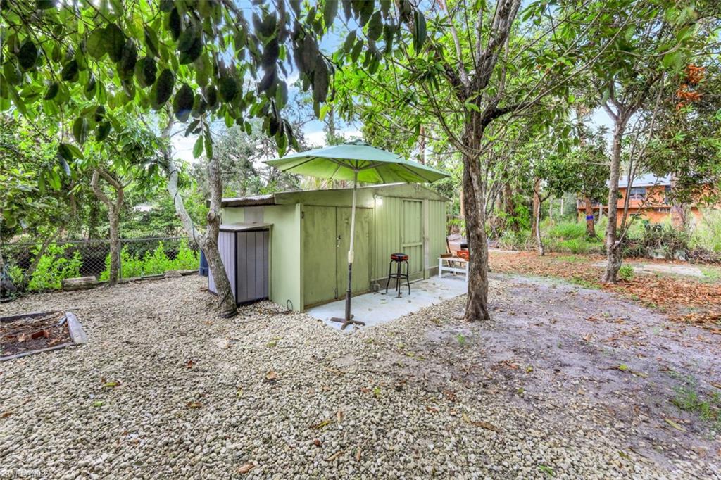 3400 Canal Street Naples, FL 34112 - Photo 21 of 32 a view of a house with a yard and tree