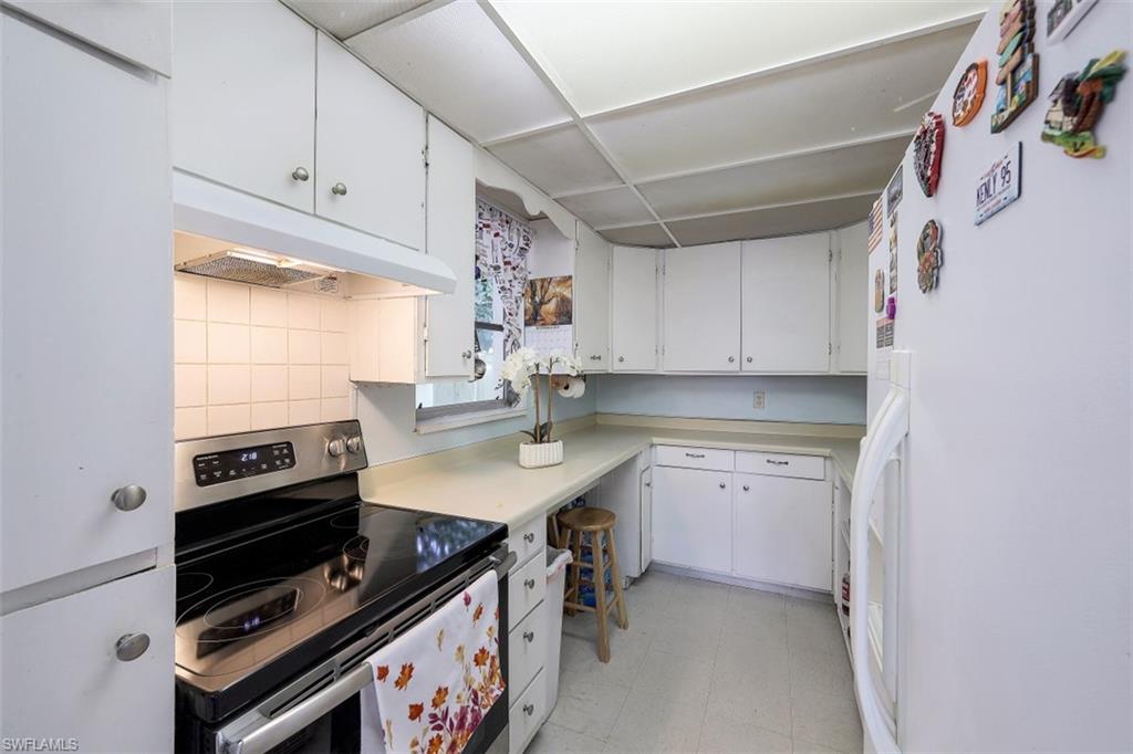 3400 Canal Street Naples, FL 34112 - Photo 5 of 32 a kitchen with a sink appliances and cabinets