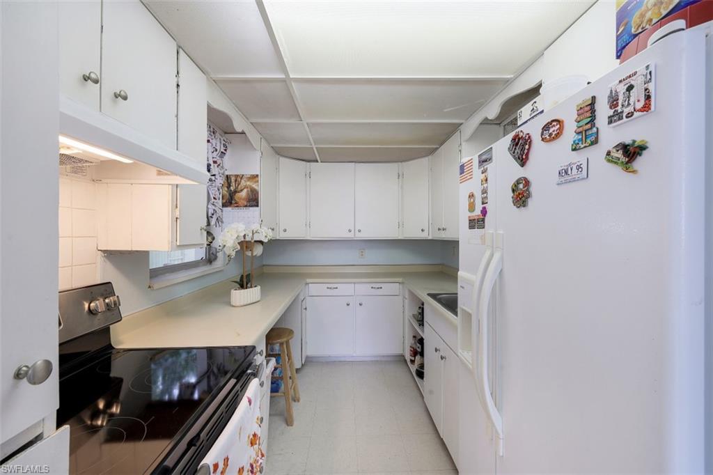 3400 Canal Street Naples, FL 34112 - Photo 7 of 32 a kitchen with a sink and a stove top oven