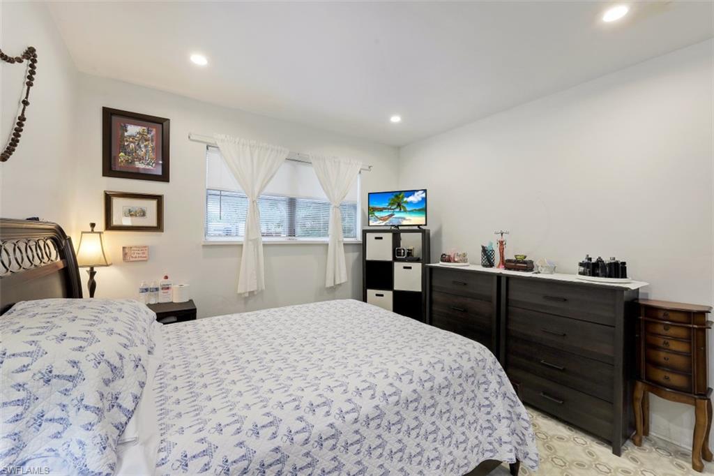 3400 Canal Street Naples, FL 34112 - Photo 8 of 32 a bedroom with a bed and cabinets