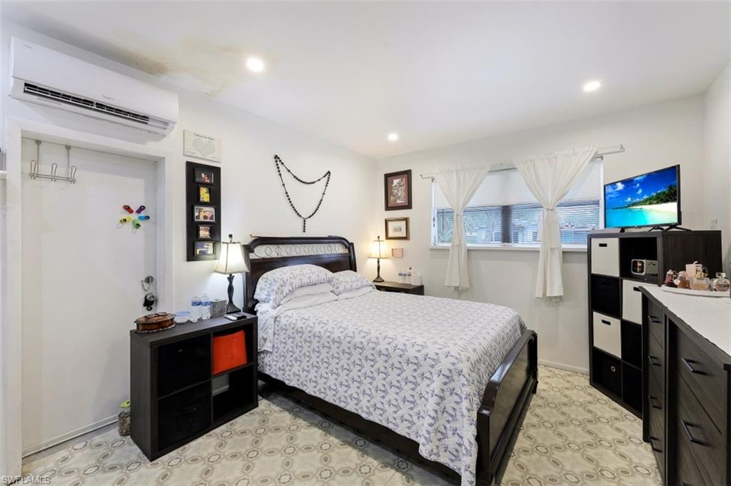 3400 Canal Street Naples, FL 34112 - Photo 10 of 32 a bedroom with a bed and a flat screen tv