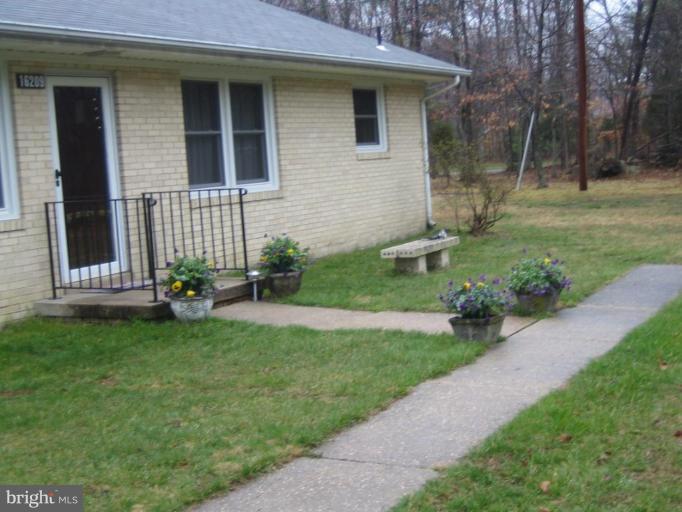 16209 Manning Road West Accokeek, MD 20607 - Photo 16 of 18 a front view of a house with garden