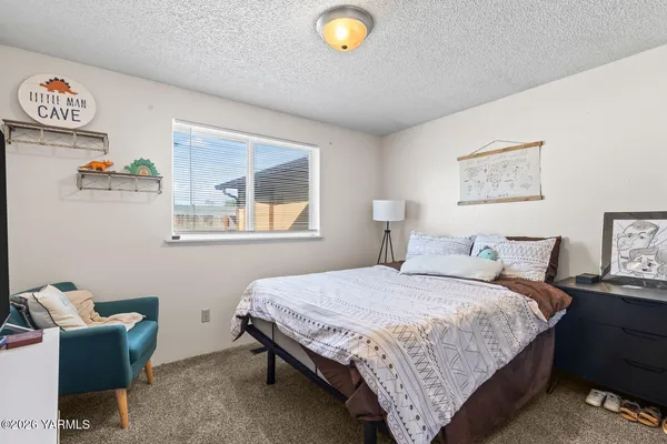 a bedroom with a bed and a couch