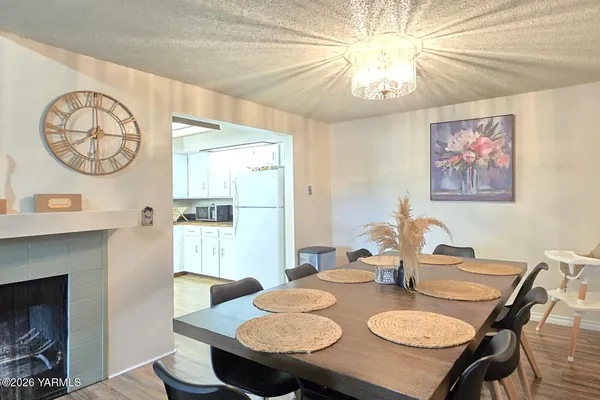 a view of a dining room with furniture and a chandelier