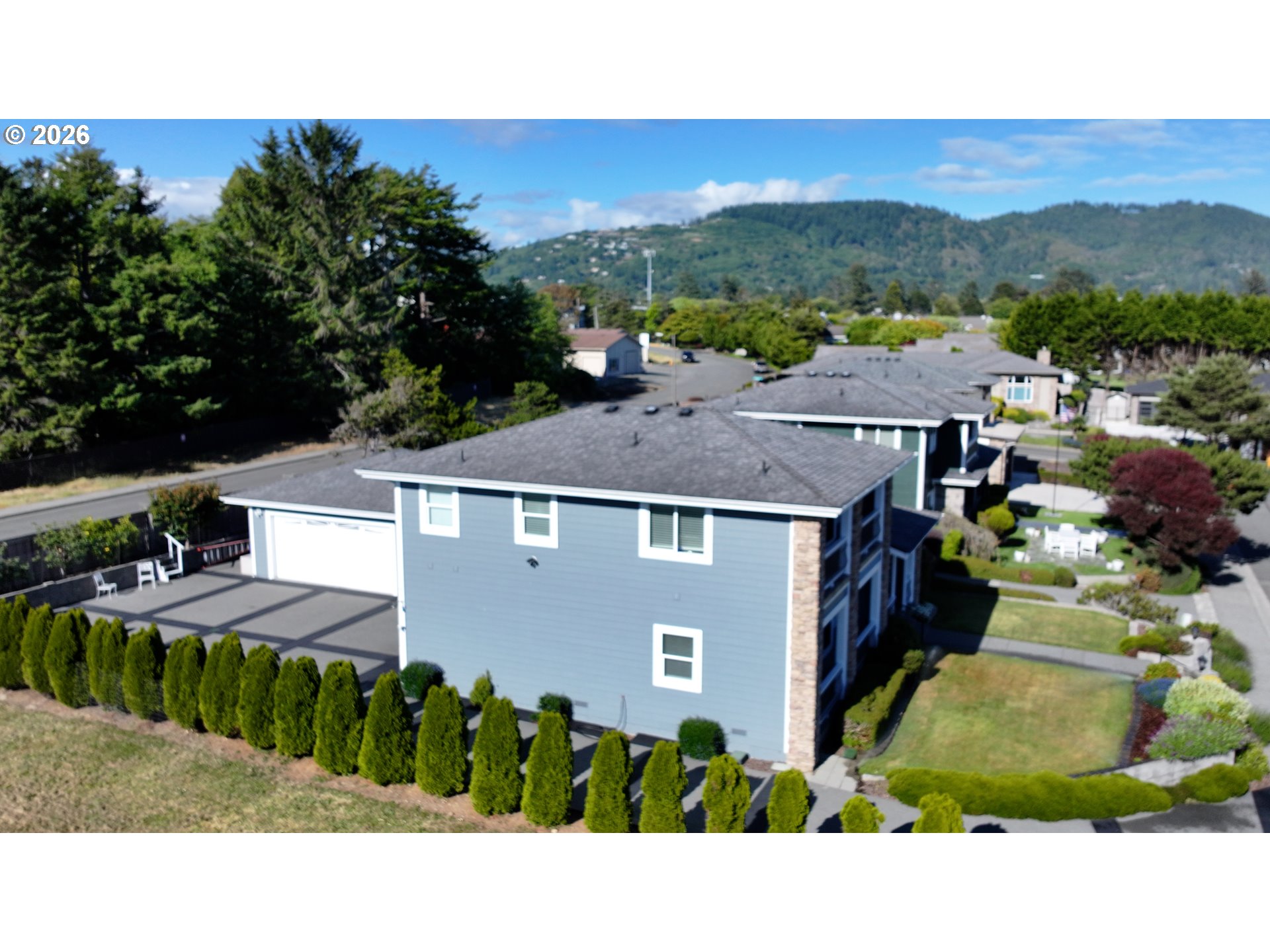 842 Chetco Point Terrace Brookings, OR 97415 - Photo 28 of 33 a view of a town with mountains in the background