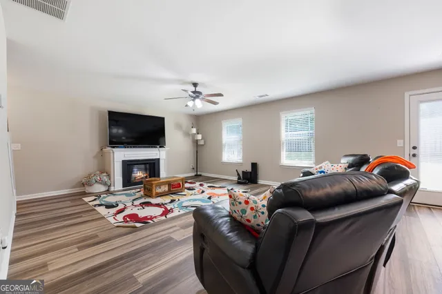 a bedroom with furniture and a flat screen tv
