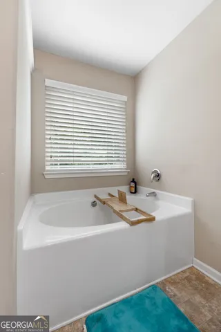 a bath tub sitting in a bathroom next to a window