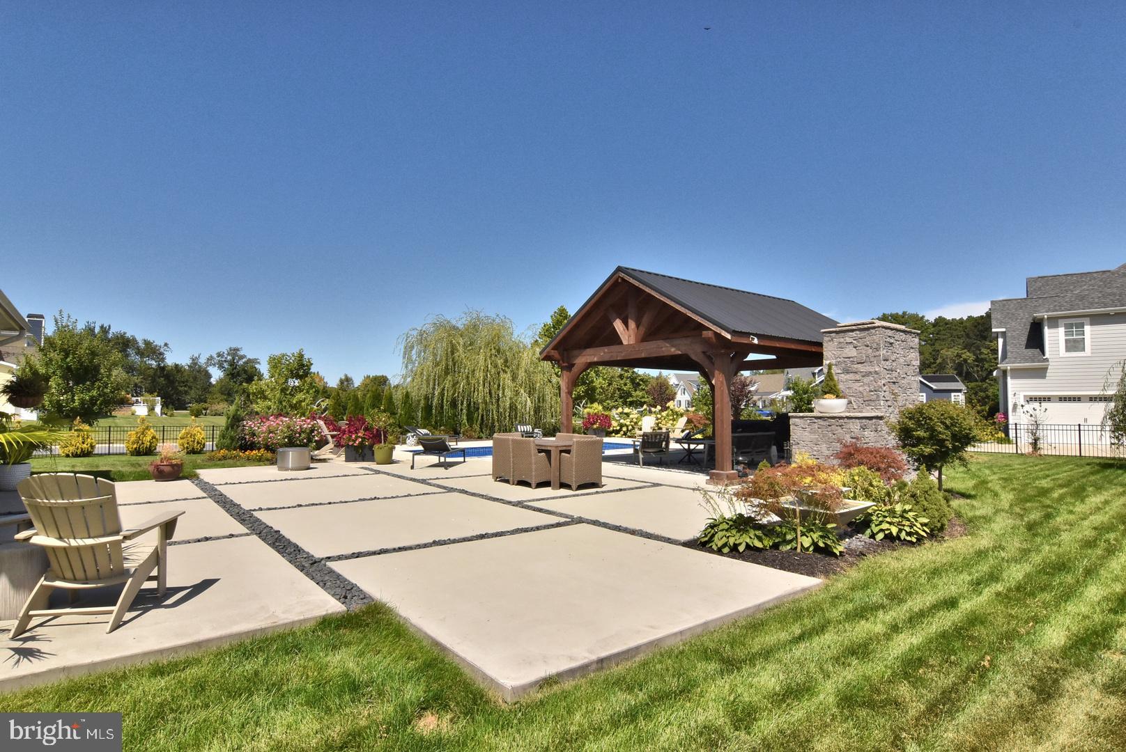 30921 Stallion Lane Lewes, DE 19958 - Photo 12 of 65 a view of a patio with couches and table and chairs and potted plants