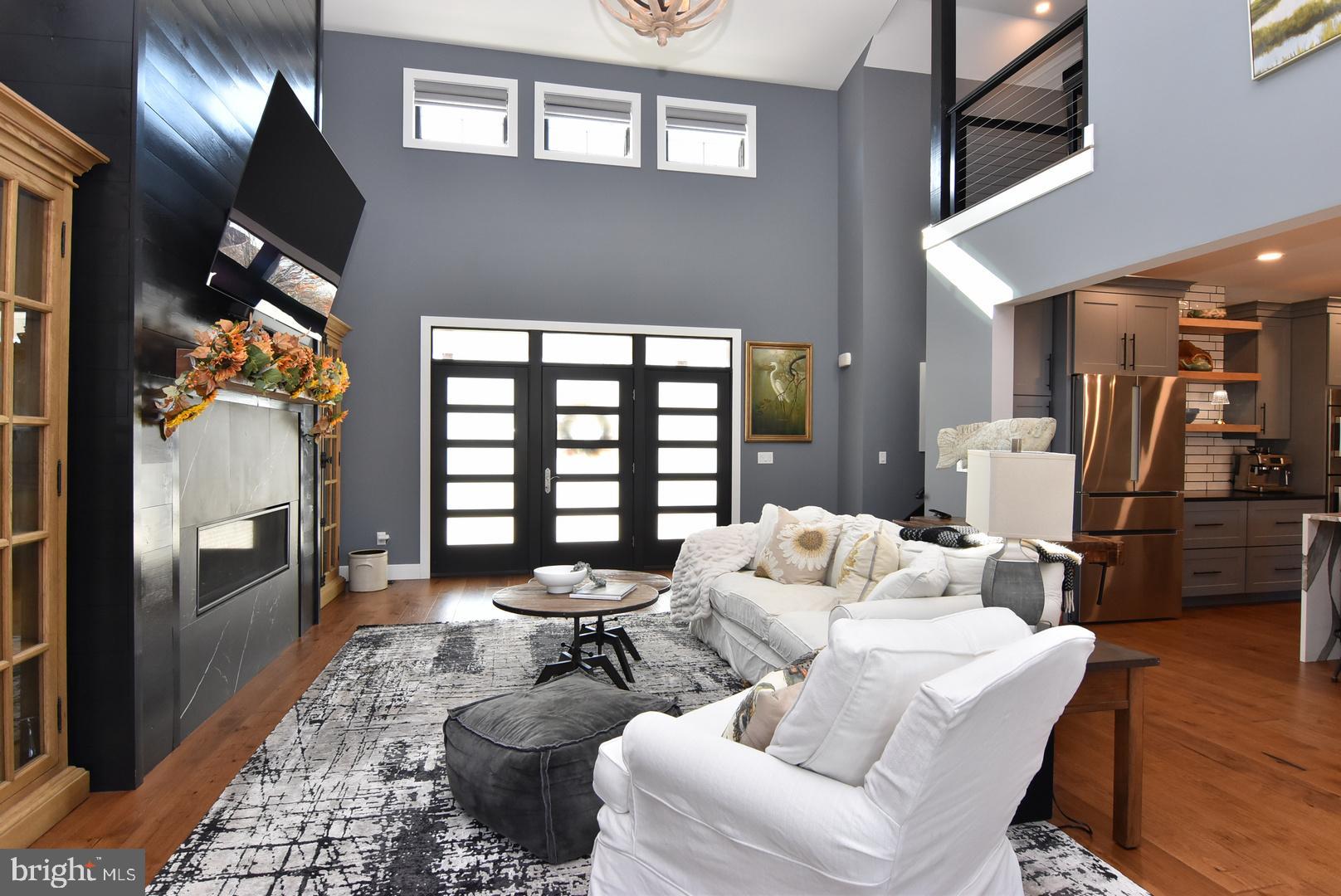 30921 Stallion Lane Lewes, DE 19958 - Photo 23 of 65 a living room with furniture and a fireplace