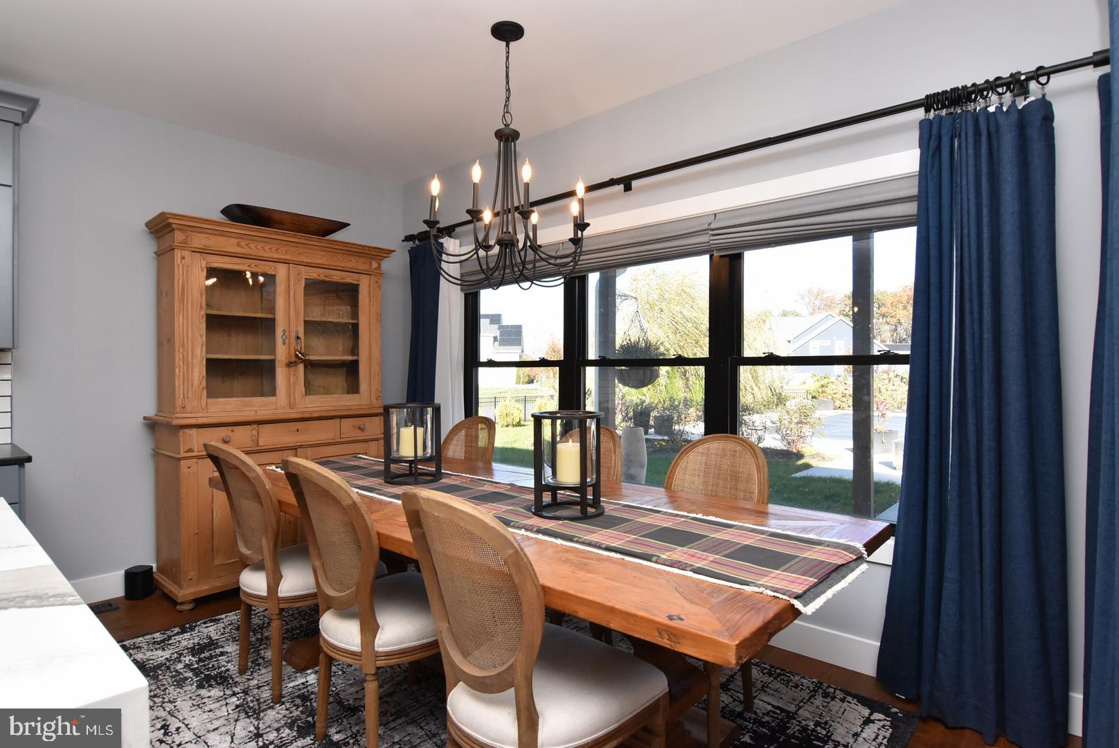 30921 Stallion Lane Lewes, DE 19958 - Photo 26 of 65 a dining room with furniture a chandelier and window