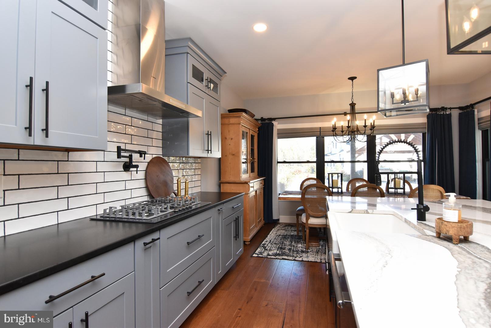 30921 Stallion Lane Lewes, DE 19958 - Photo 29 of 65 a large kitchen with granite countertop a large window and stainless steel appliances