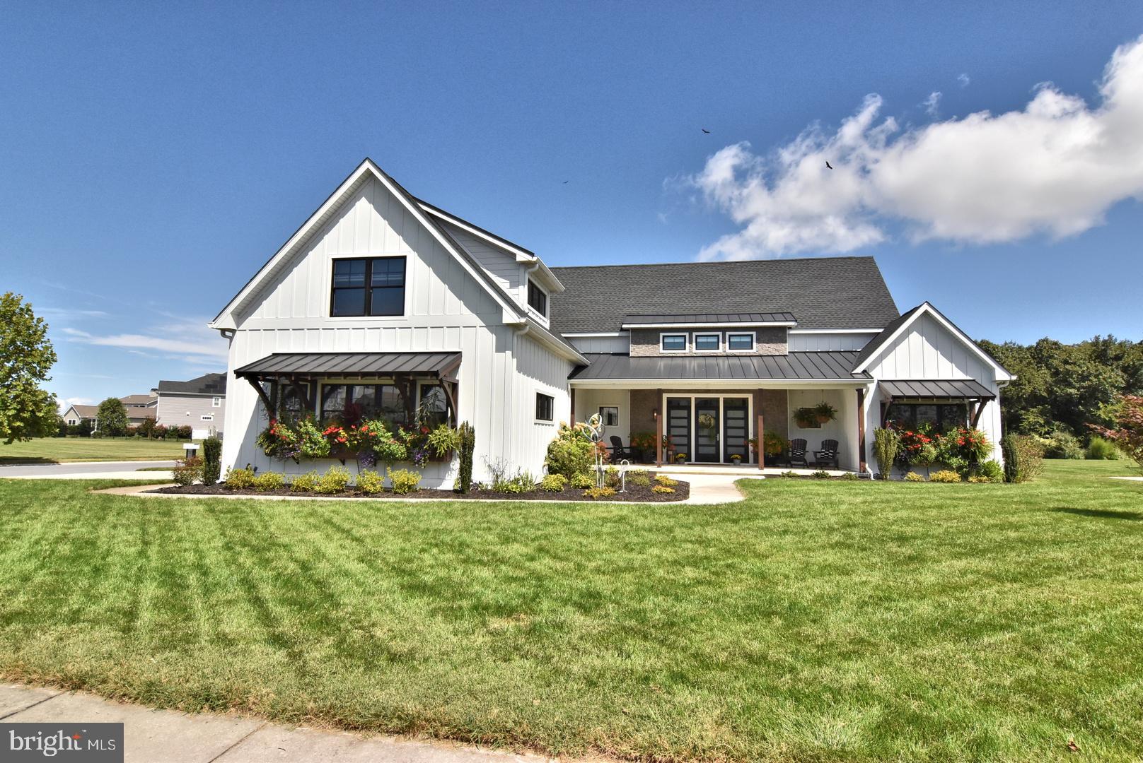 30921 Stallion Lane Lewes, DE 19958 - Photo 3 of 65 a front view of a house with a yard