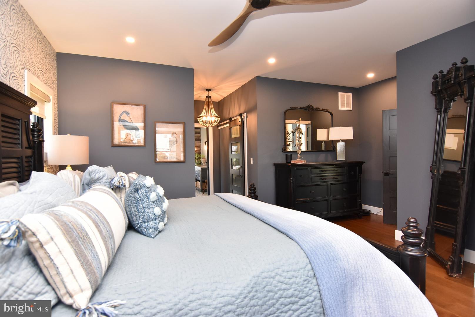 30921 Stallion Lane Lewes, DE 19958 - Photo 33 of 65 a bedroom with a bed and a flat screen television