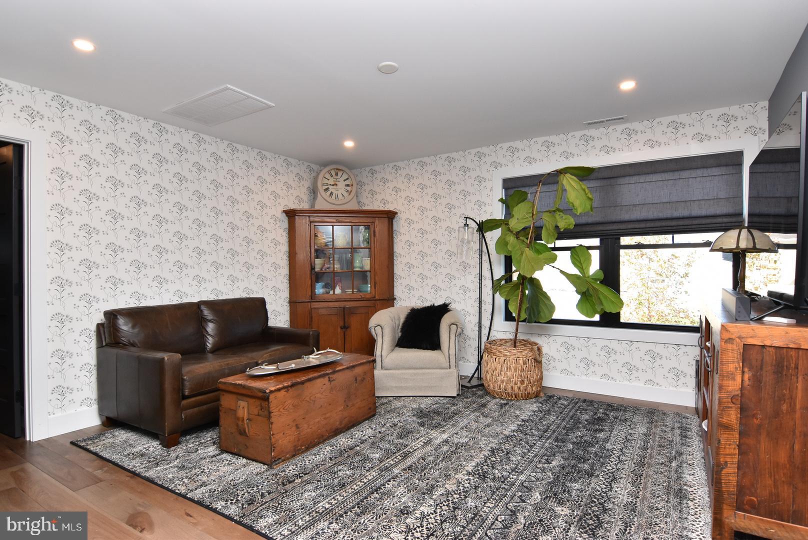 30921 Stallion Lane Lewes, DE 19958 - Photo 39 of 65 a living room with furniture and a flat screen tv
