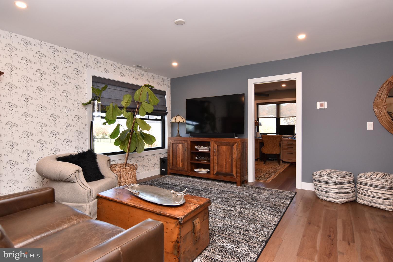 30921 Stallion Lane Lewes, DE 19958 - Photo 40 of 65 a living room with furniture and a flat screen tv