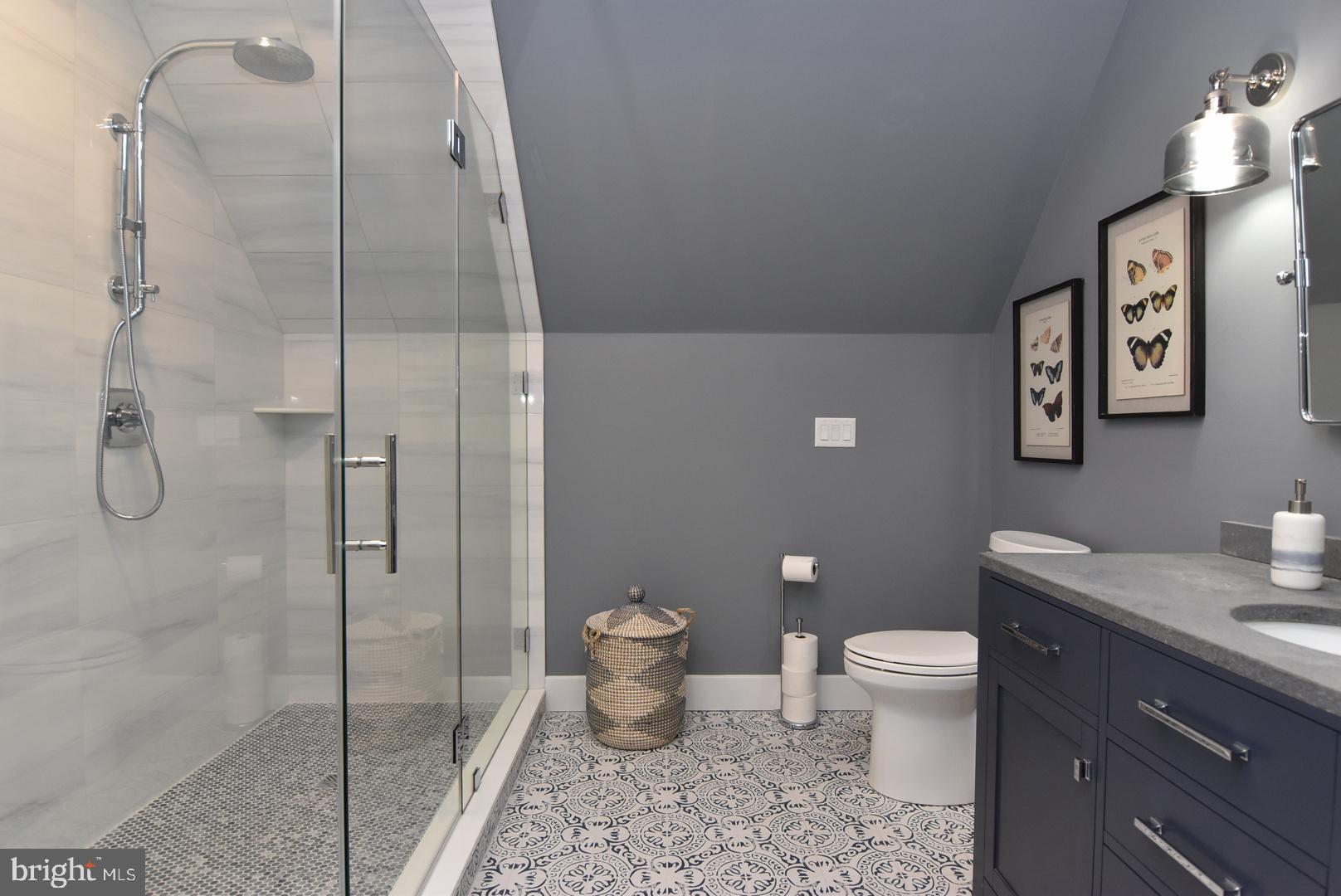 30921 Stallion Lane Lewes, DE 19958 - Photo 44 of 65 a bathroom with a granite countertop toilet and a shower