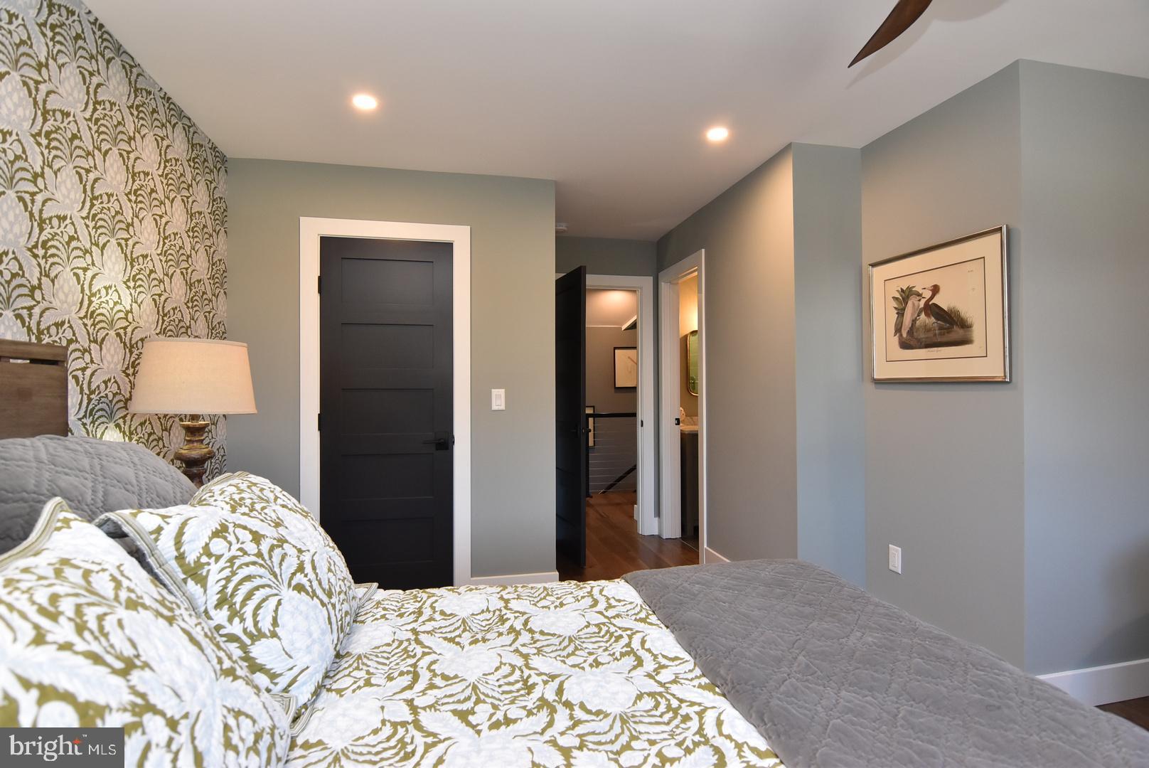 30921 Stallion Lane Lewes, DE 19958 - Photo 49 of 65 a bedroom with a bed and lamp