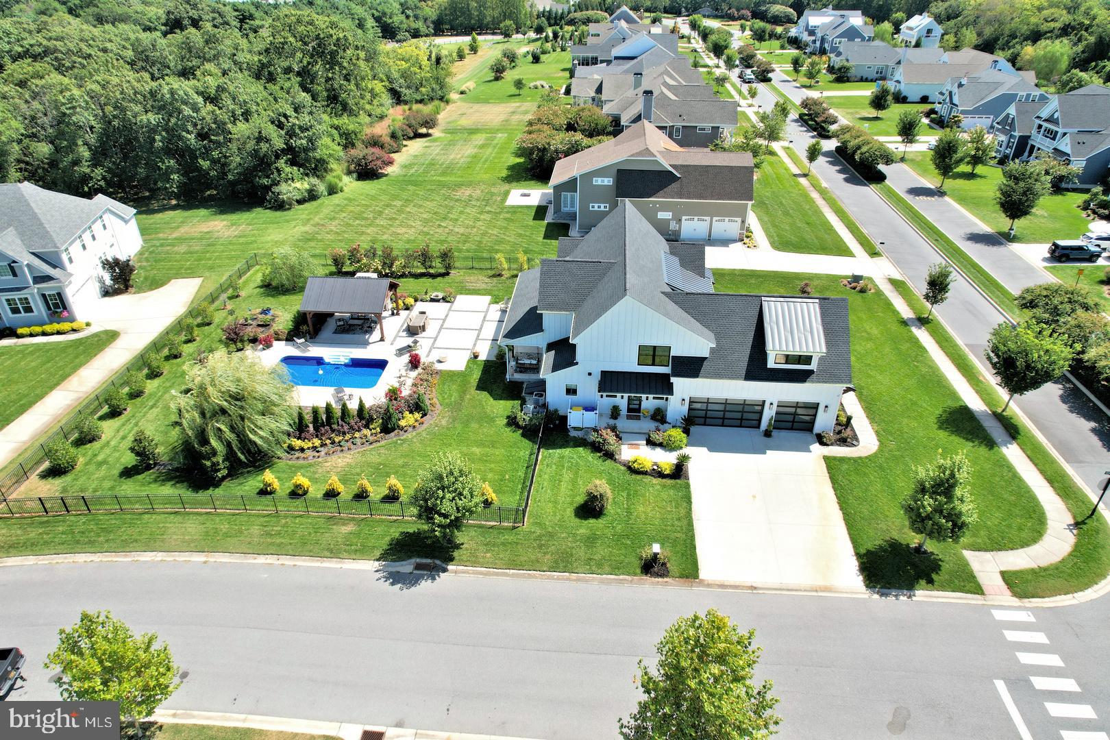 30921 Stallion Lane Lewes, DE 19958 - Photo 55 of 65 an aerial view of a house with a garden and trees