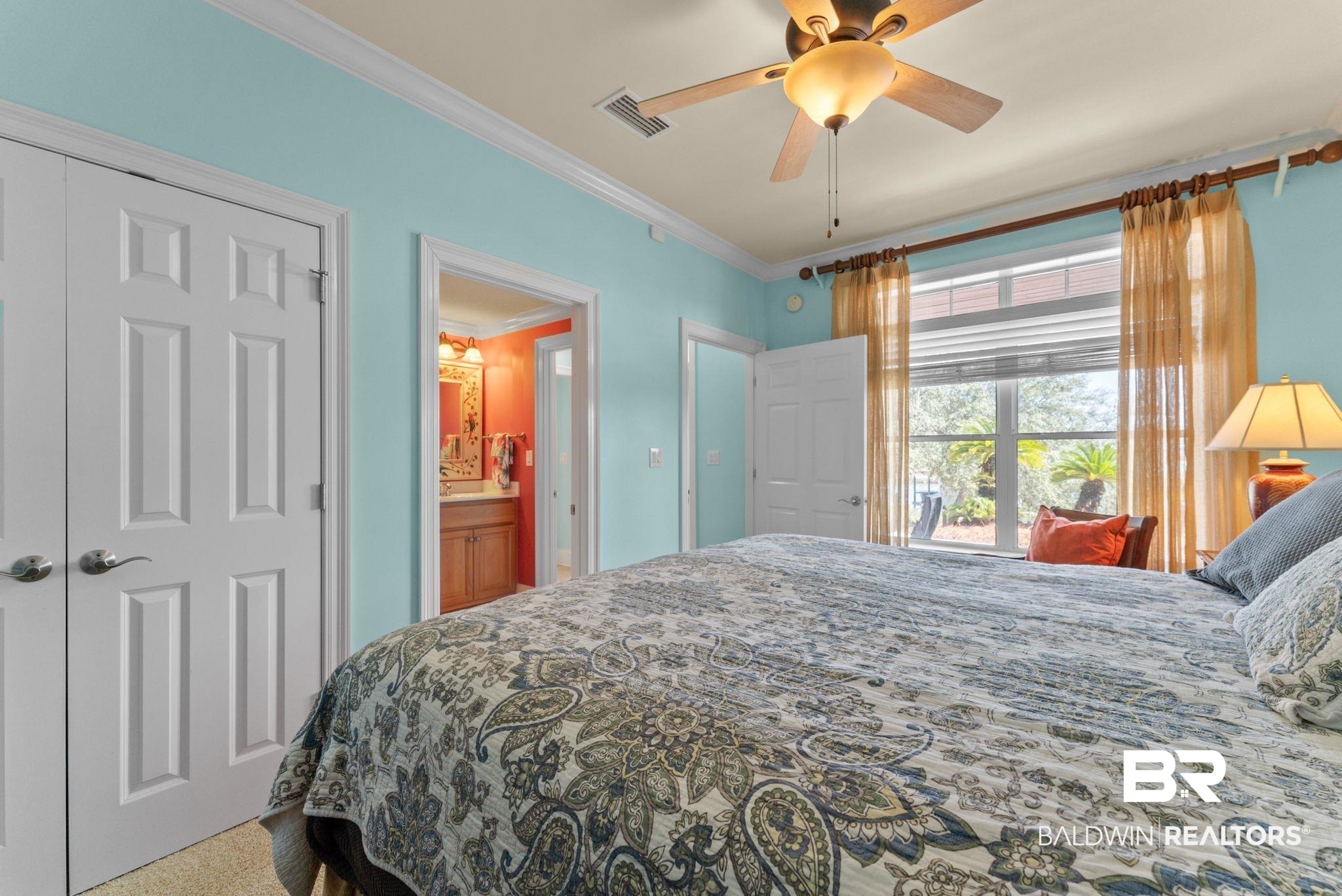 30818 River Road Orange Beach, AL 36561 - Photo 65 of 81 Carpeted bedroom featuring ornamental molding, ceiling fan, and connected bathroom