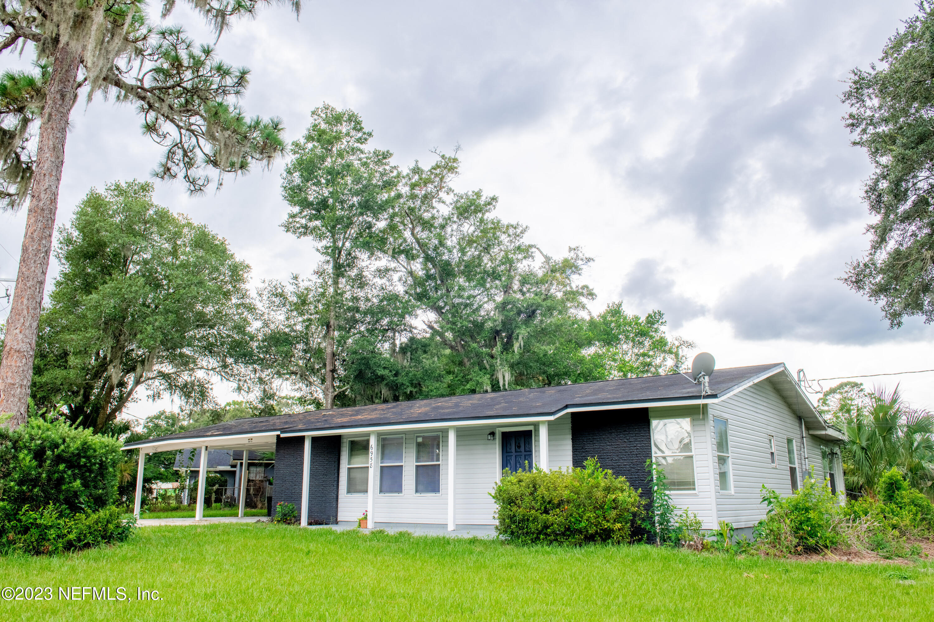 6958 Champlain Road Jacksonville, FL 32208 - Photo 1 of 34 a front view of a house with a yard