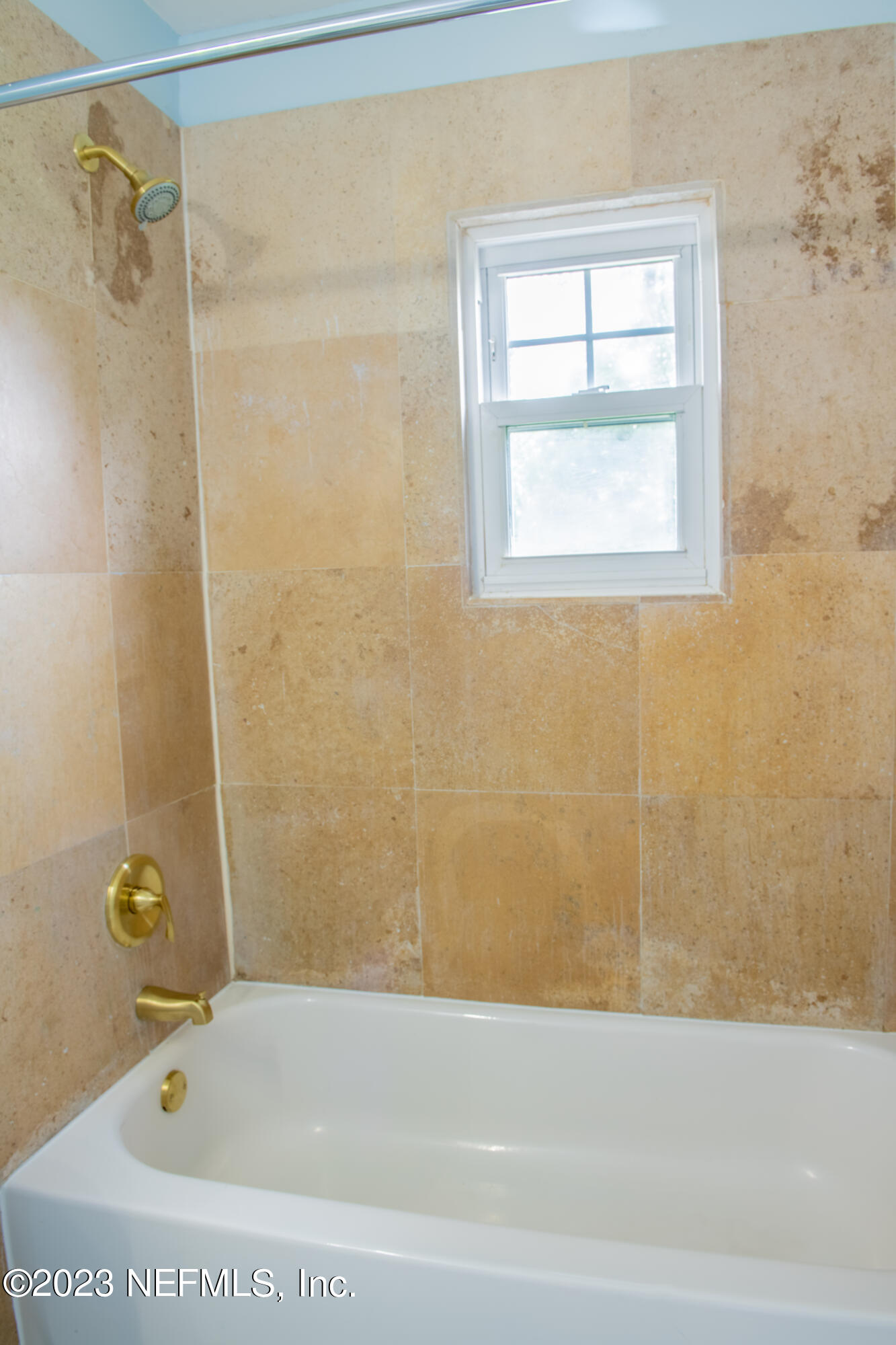 6958 Champlain Road Jacksonville, FL 32208 - Photo 21 of 34 a bathroom with a bathtub and a shower