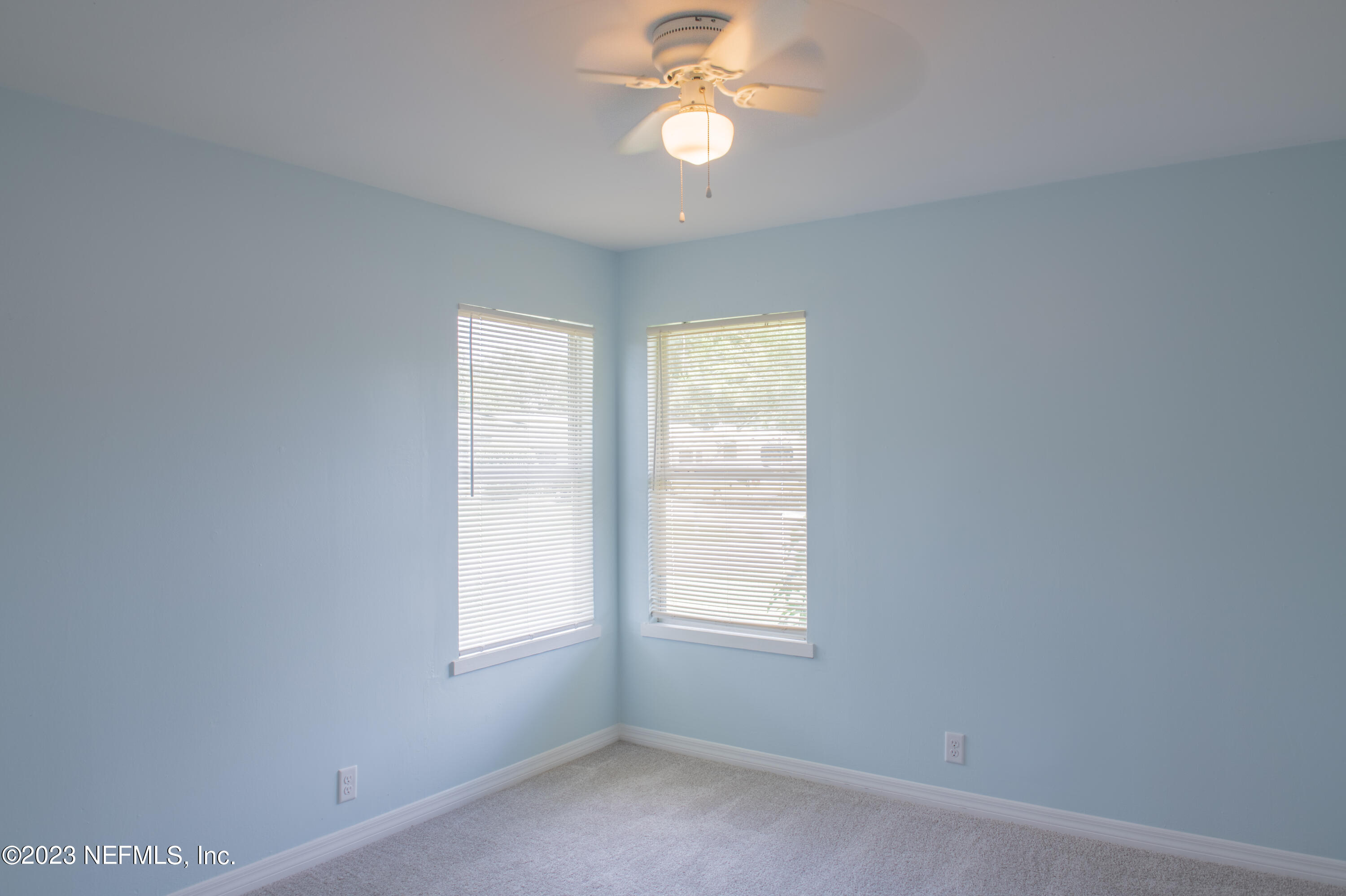 6958 Champlain Road Jacksonville, FL 32208 - Photo 24 of 34 an empty room with a window and a fan