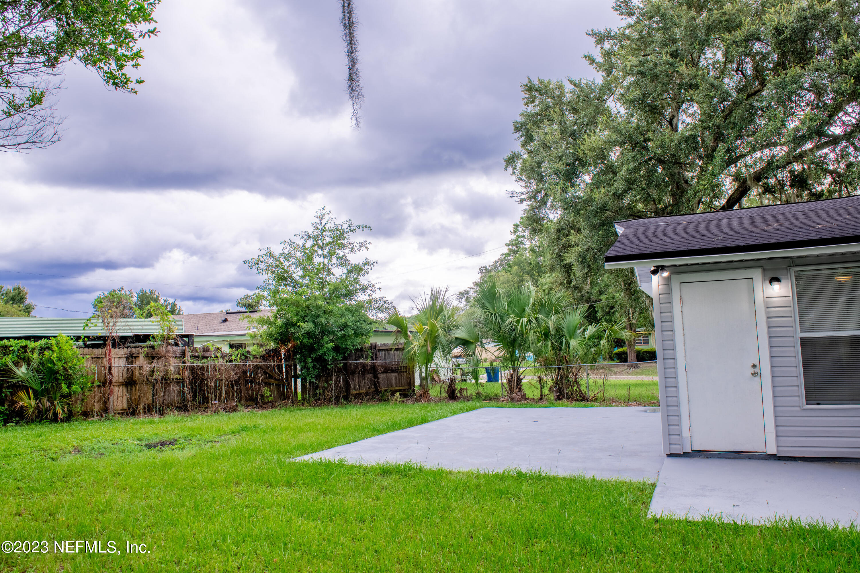 6958 Champlain Road Jacksonville, FL 32208 - Photo 31 of 34 a view of yard with seating area and green space