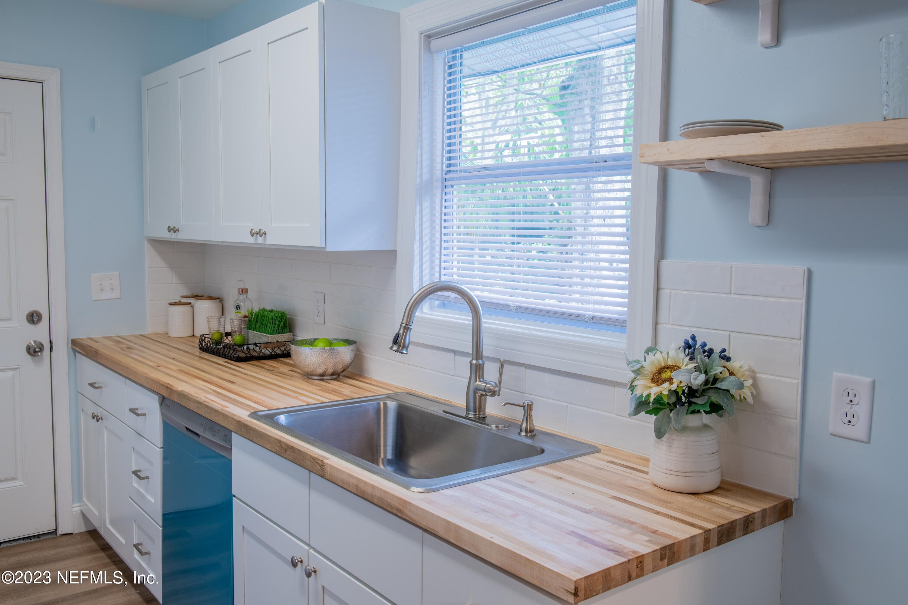 6958 Champlain Road Jacksonville, FL 32208 - Photo 4 of 34 a kitchen with a sink a counter and cabinets