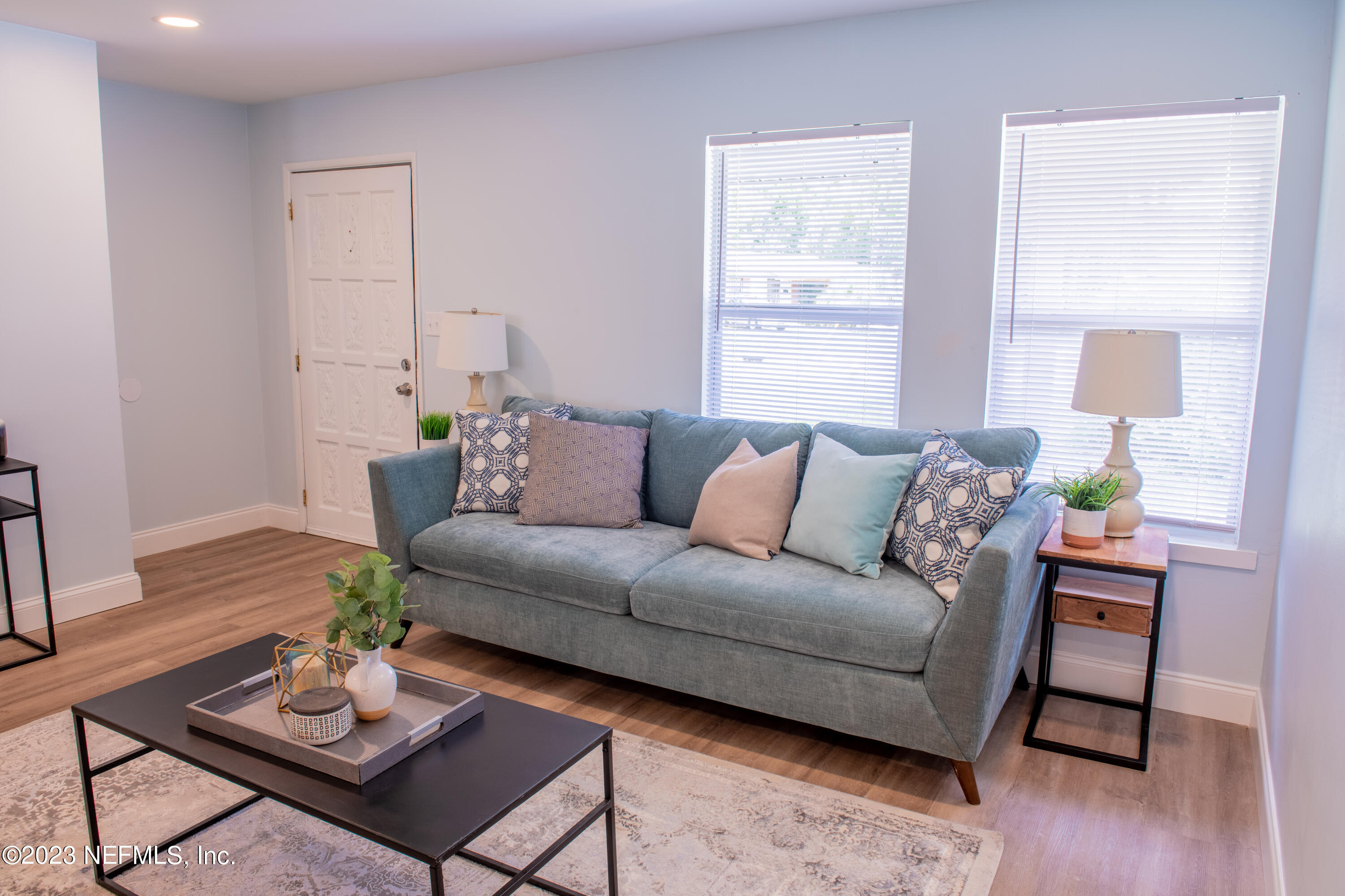 6958 Champlain Road Jacksonville, FL 32208 - Photo 7 of 34 a living room with furniture and wooden floor