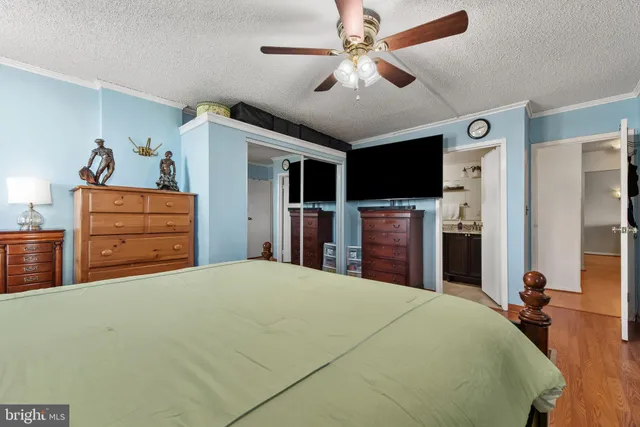 a bedroom with a large bed and a chandelier