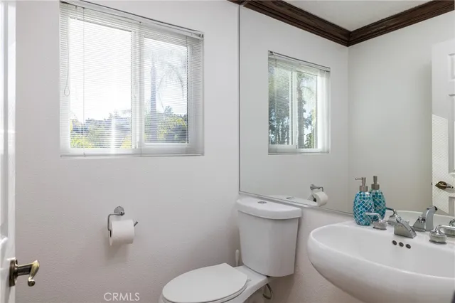 a bathroom with a granite countertop sink toilet mirror and shower