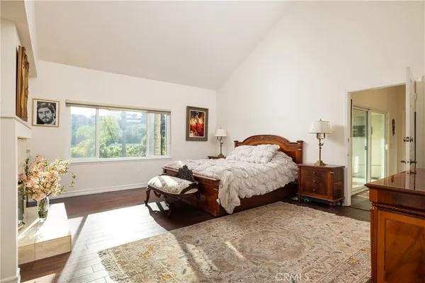 a bathroom with a granite countertop sink toilet a large mirror a shower and a bathtub