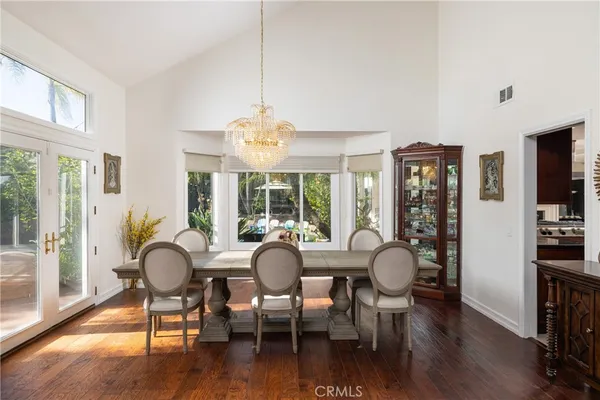 a view of a dining room with furniture wooden floor and chandelier