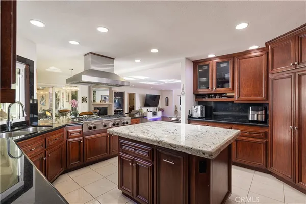 a bathroom with a granite countertop sink mirror vanity and toilet