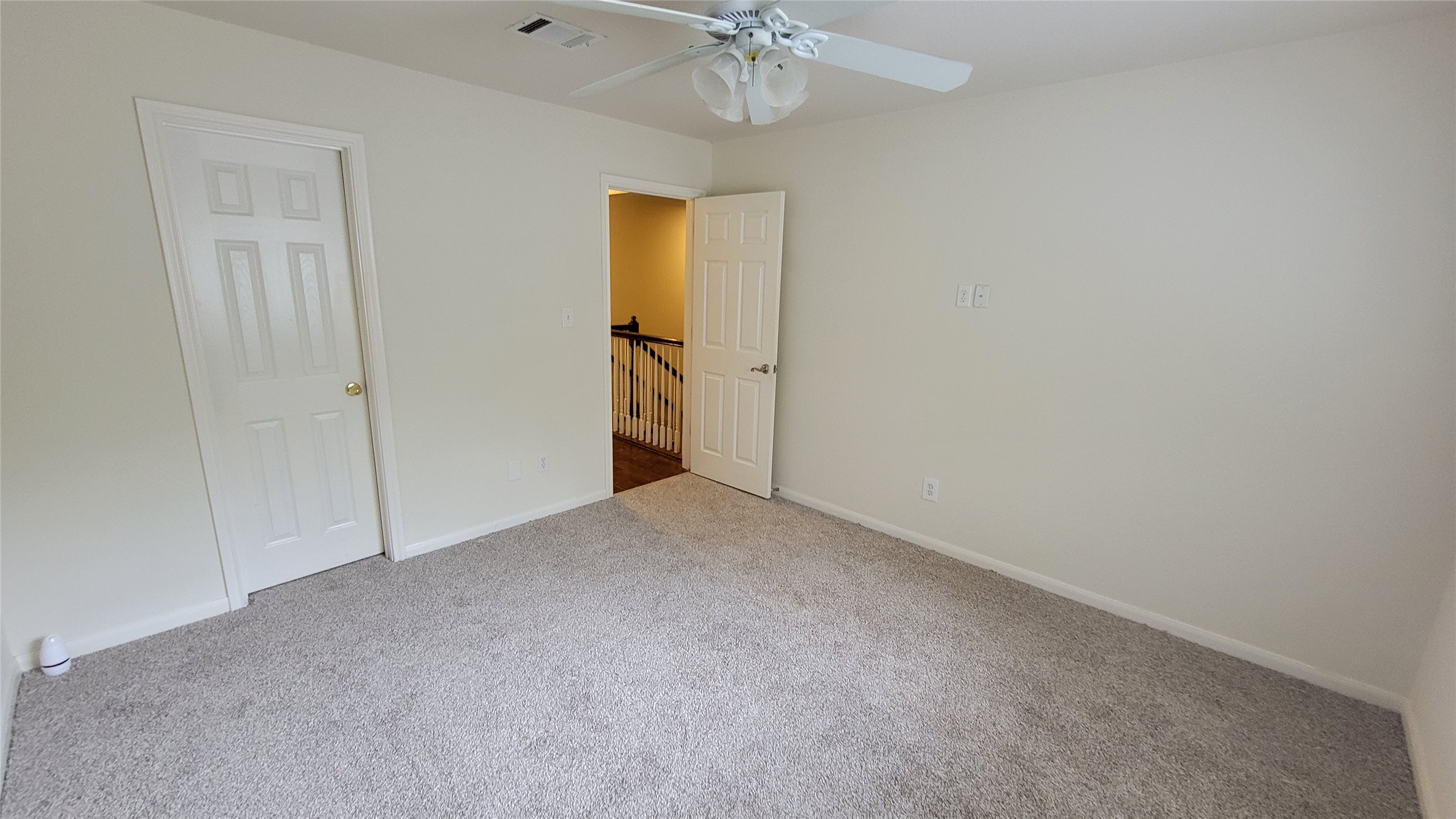 2832 Grimes Ranch Road Austin, TX 78732 - Photo 20 of 37 A well-lit room offers comfort with soft carpeting and an overhead ceiling fan.