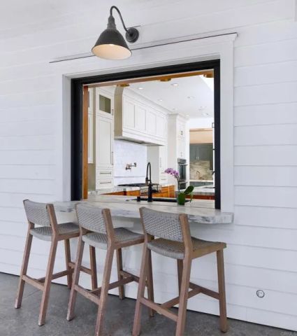 a kitchen with a table chairs and microwave