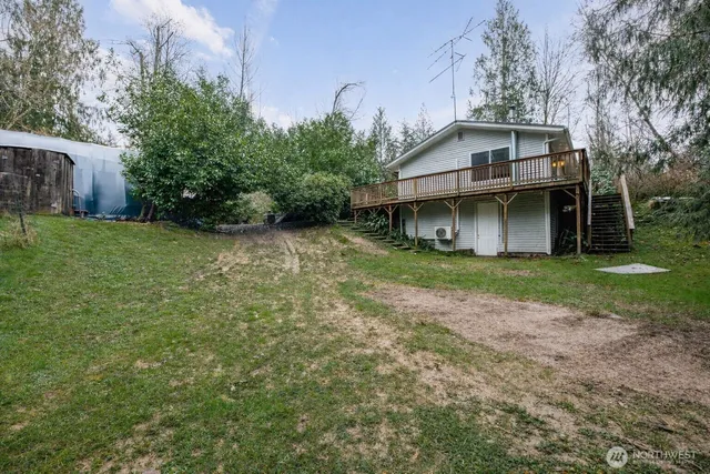 a view of a field with trees in the background