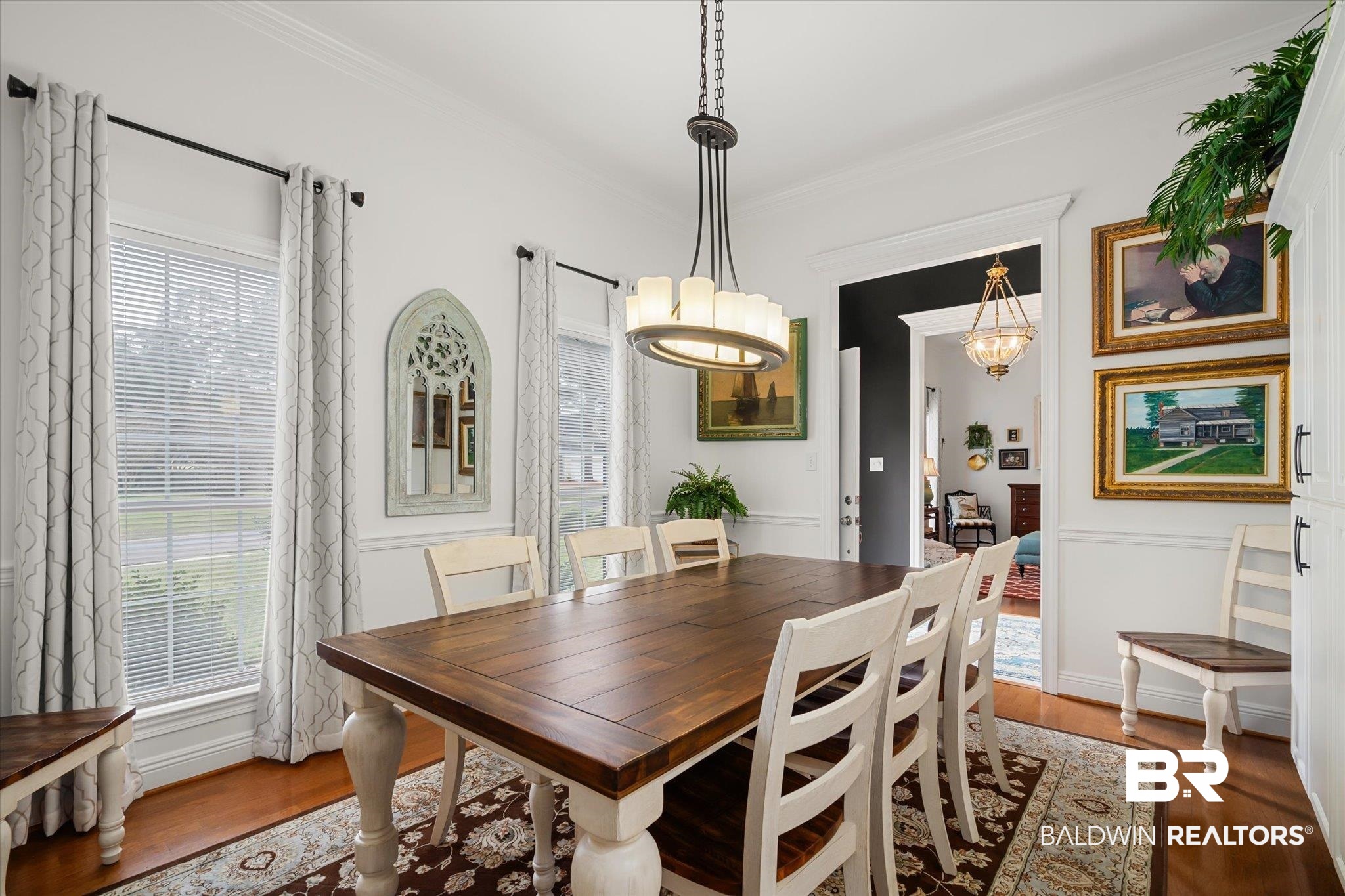 19924 Hunters Loop Fairhope, AL 36532 - Photo 5 of 40 Dining room featuring a wealth of natural light, crown molding, an inviting chandelier, and hardwood / wood-style flooring