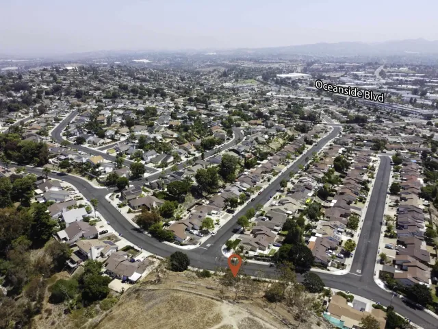 an aerial view of a residential house with outdoor space