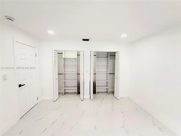 a view of empty room with closet