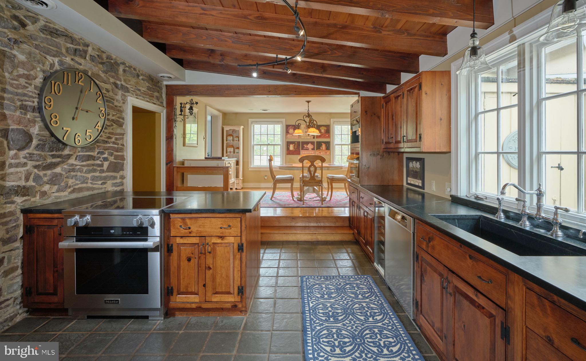 2135 South Sugan Road New Hope, PA 18938 - Photo 9 of 46 Kitchen with exposed beams and stone