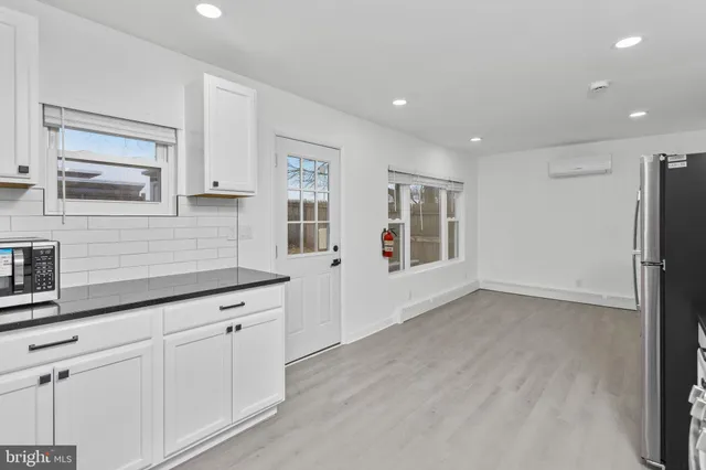 a view of a kitchen with cabinets and wooden floor