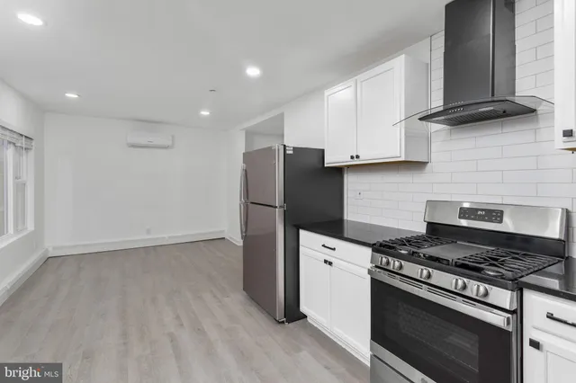 a kitchen with granite countertop a stove and a refrigerator