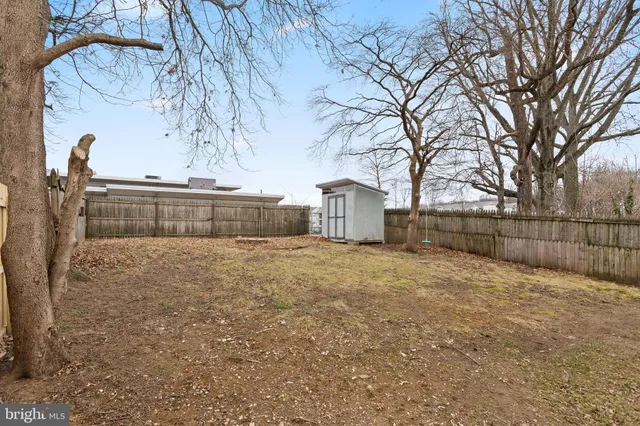 a view of yard covered with snow in front of house