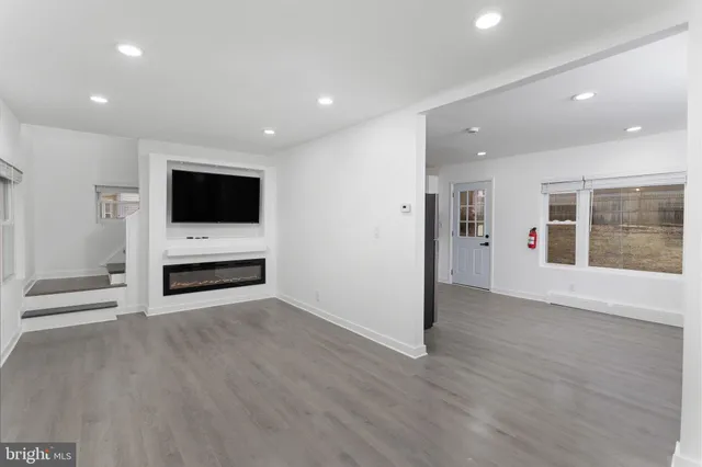 a view of kitchen with furniture flat screen tv and staircase