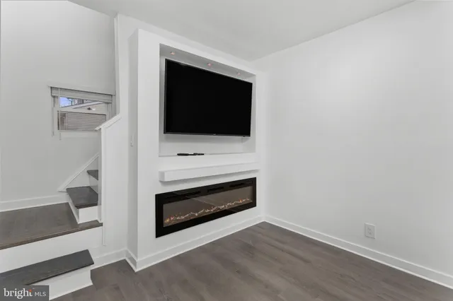 a living room with a fireplace and a flat screen tv