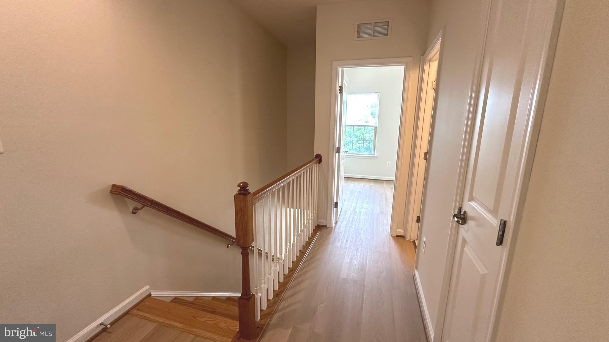7343 Old Calvary Road Hanover, MD 21076 - Photo 26 of 35 a view of a hallway with wooden floor and staircase