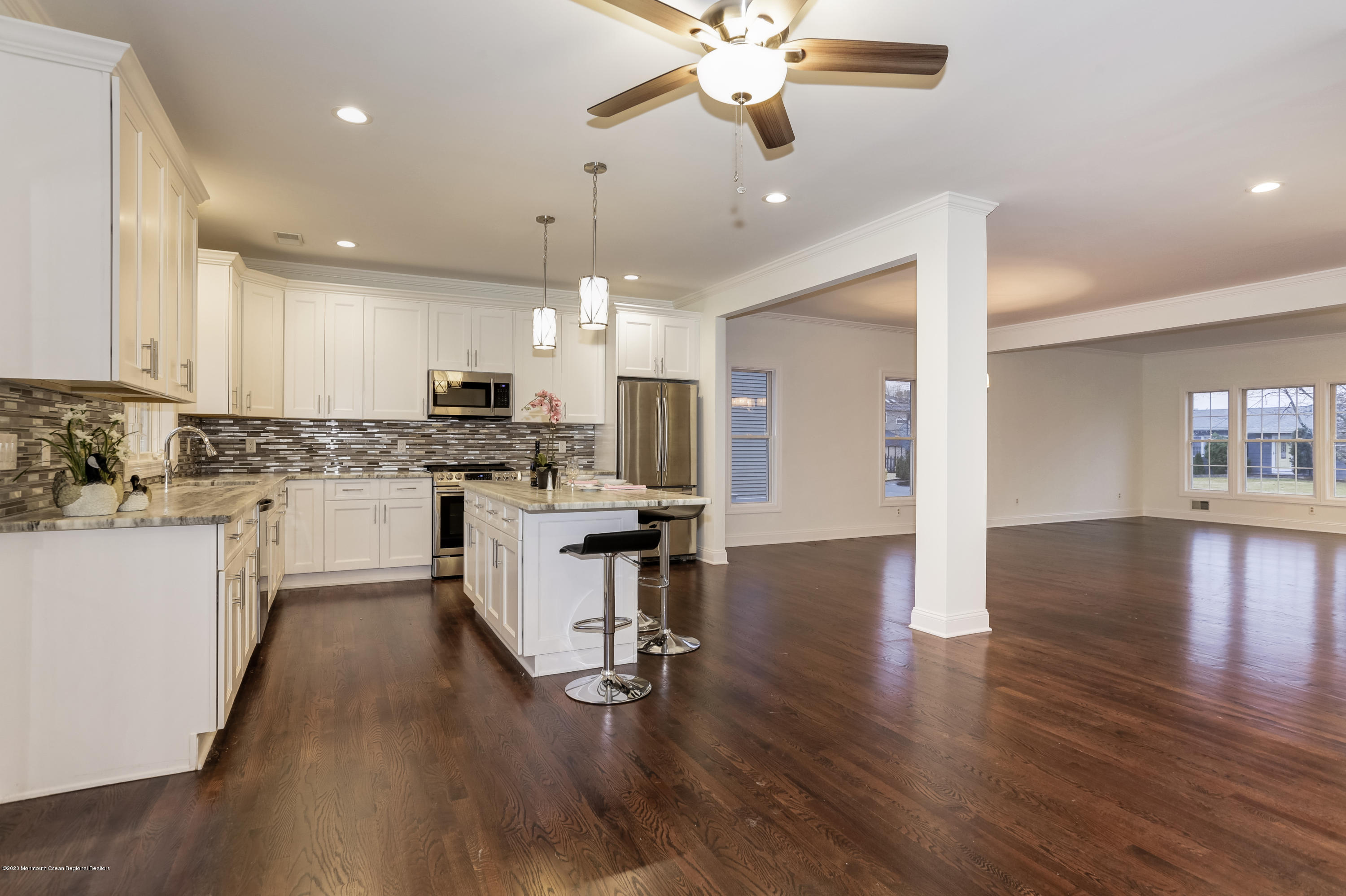 153 Royal Drive Brick, NJ 08723 - Photo 11 of 32 an open kitchen with wooden floor and stainless steel appliances