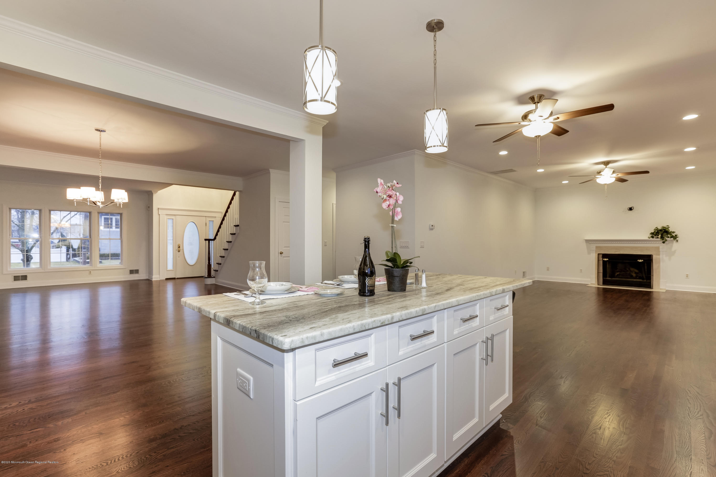 153 Royal Drive Brick, NJ 08723 - Photo 13 of 32 a kitchen with a sink chandelier and wooden floor