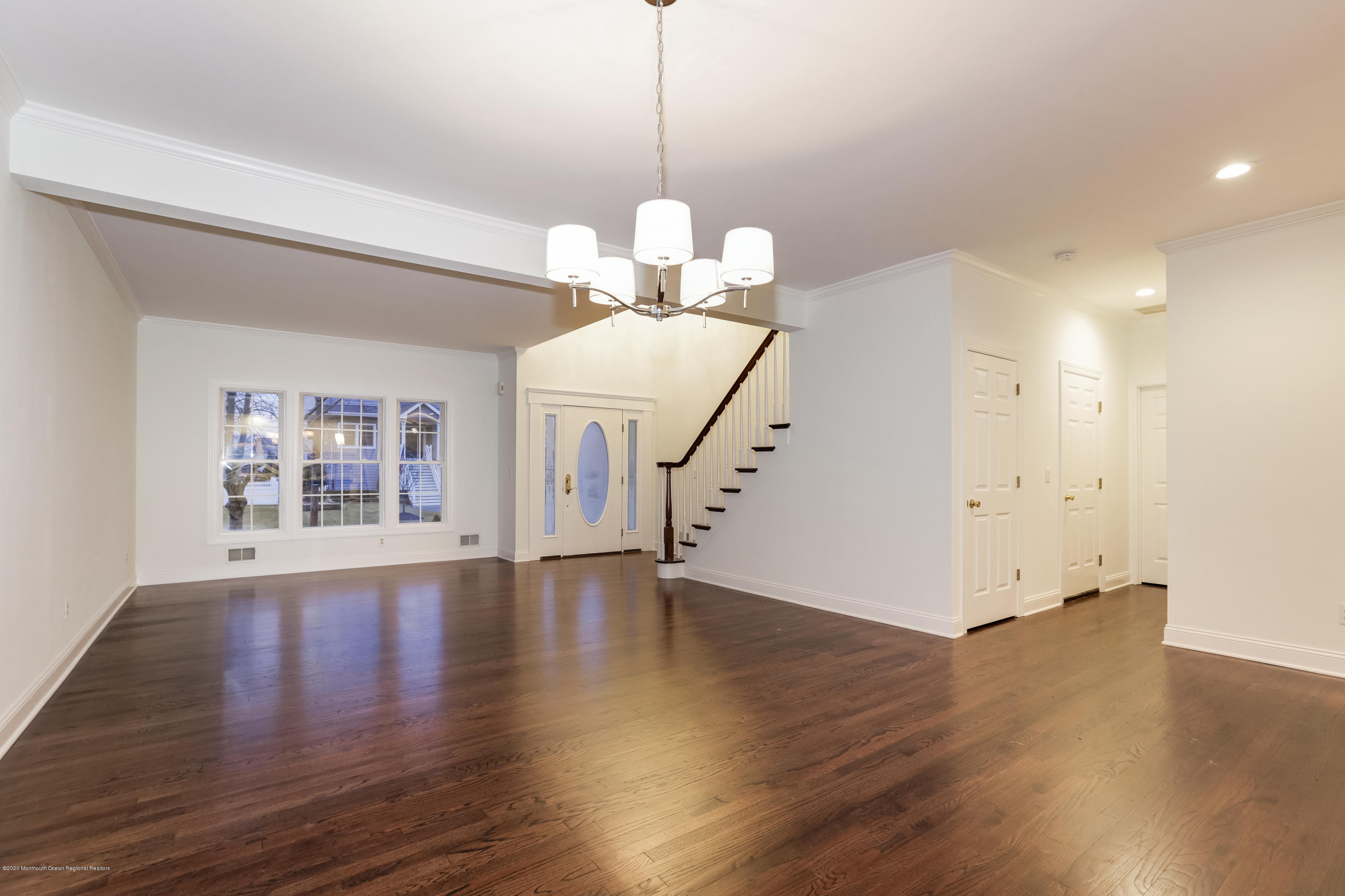 153 Royal Drive Brick, NJ 08723 - Photo 16 of 32 a view of an empty room with wooden floor and a chandelier